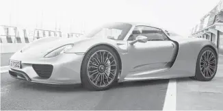  ?? PORSCHE ?? Hybrid technology lets the race-car-like Porsche 918 Spyder emulate the frugality of a fuel-sipping subcompact.