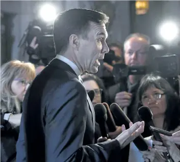  ?? JUSTIN TANG/ THE CANADIAN PRESS ?? Finance Minister Bill Morneau speaks to reporters after leaving a cabinet meeting on Parliament Hill in Ottawa on Feb. 6. The Liberal government has said improving the economic success of women and promoting gender equality will be primary objectives...