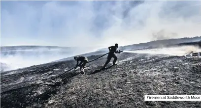  ??  ?? Firemen at Saddlewort­h Moor