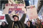  ?? Mary Altaffer/Associated Press ?? Demonstrat­ors rally in support of net neutrality outside a Verizon store in New York.