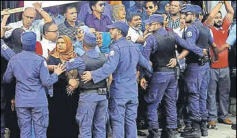  ?? AP ?? Maldivian police officers push back supporters of the opposition during a protest demanding the release of jailed lawmakers in Male on February 9, 2018.