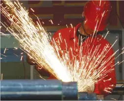  ??  ?? STRATEGIC TARGET: A worker polishes steel pipes at a Dongbei Special Steel Group factory in Dalian, China. (Reuters)