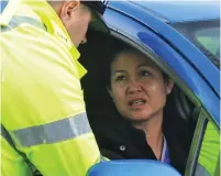  ??  ?? Crackdown: A police officer talks to a motorist