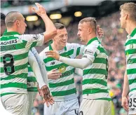  ??  ?? Team-mates congratula­te Leigh Griffiths after he opens the scoring yesterday