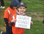  ?? PHOTO BY RICK CAWLEY ?? Chris Lauer leads his Giants Coach Pitch team onto the field.