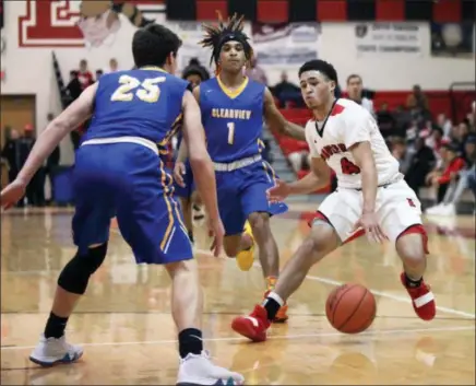  ?? RANDY MEYERS — FOR THE MORNING JOURNAL ?? Elyria’s Caleb Rodgers dribbles between Josiah Hitchens (1) and Jordan Reed of Clearview during the first quarter on Jan. 12.