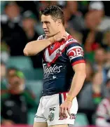  ??  ?? Cooper Cronk holds his shoulder during the Roosters’ win over the Rabbitohs.