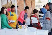  ??  ?? Food boxes provided by Feed the Children are given to students Friday at Hillcrest Elementary in south Oklahoma City.