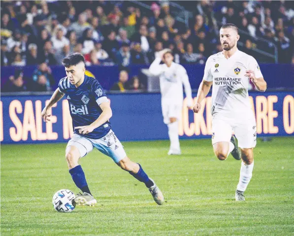  ?? — WHITECAPS FC ?? Ryan Raposo races upfield in front of L.A. Galaxy defender Giancarlo González during his profession­al debut with the Vancouver Whitecaps on Saturday. Raposo earned an assist on the only goal, by Tosaint Ricketts, in the 1-0 win.