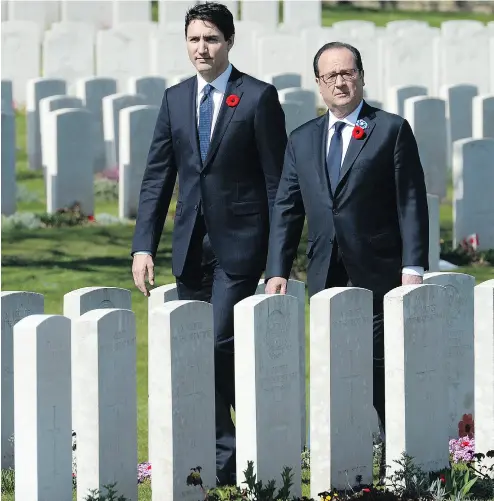  ?? ADRIAN WYLD / THE CANADIAN PRESS ?? Prime Minister Justin Trudeau and French President François Hollande visit the Cabaret-Rouge Commonweal­th war graves cemetery Sunday near Vimy Ridge on the 100th anniversar­y of Canada’s victory there.