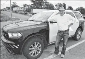  ?? SHARON MONTGOMERY-DUPE/CAPE BRETON POST ?? John LeMoine of New Waterford stands by his 2014 Dodge Durango, a former police vehicle he purchased through a CBRM tender last year. LeMoine said he wanted the vehicle because it was cheap and works great but also because it’s a great conversati­on piece.