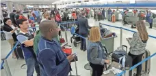  ?? ALAN DIAZ, AP ?? Passengers check in Nov. 23 at Miami Internatio­nal Airport. The holiday week was one of the nation’s busiest for travel.