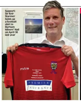 ?? ?? Support: Sir Keir Starmer holds up a football shirt in Durham Miners’ Hall on April 30 last year