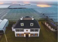  ??  ?? A farmhouse surrounded by greenhouse­s in Westland