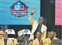  ?? ASSOCIATED PRESS FILE PHOTO ?? Enshrinee Eric Dickerson is introduced during the 2014 Pro Football Hall of Fame enshrineme­nt ceremony, in Canton, Ohio. A group of Pro Football Hall of Famers is demanding health insurance coverage and a share of NFL revenues or else those former players will boycott the induction ceremonies.