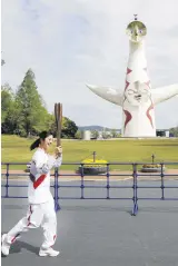  ??  ?? Former Japanese swimmer Aya Terakawa with the Olympic torch, Osaka, Japan, April 13, 2021.