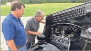  ?? Doug Walker / Rome News-Tribune ?? Clayton Vick (left) and Wayne Vick check out the engine compartmen­t of a 1935 Ford they will drive in the Great Race.