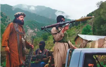  ?? Gulf News Archives ?? Pakistani Taliban patrol Shawal in the tribal region of SouthWazir­istan in this file picture.