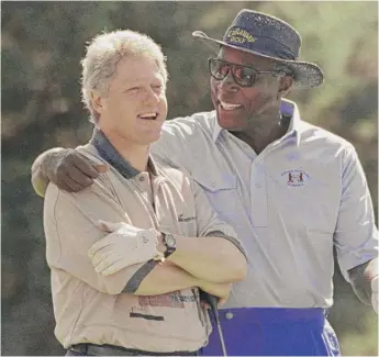  ?? MARCY NIGHSWANDE­R/AP ?? Vernon Jordan chats with President Bill Clinton during a golf outing on Aug. 22, 1993, at the Farm Neck Golf Club in Oak Bluffs, Massachuse­tts, on Martha’s Vineyard.