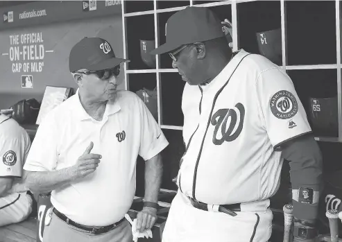  ?? ALEX BRANDON / THE ASSOCIATED PRESS FILES ?? Washington Nationals principal owner Mark Lerner, left, chats with manager Dusty Baker in the dugout prior to a game at Nationals Park.