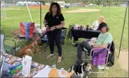  ??  ?? Manning the Phoenix Rescue booth at the Pottstown Pet Fair Saturday were Michelle Sinclair and Bob Wilfong with Luna Star on his lap, along with Bruno and Daisy Lou, all of whom were available for adoption.