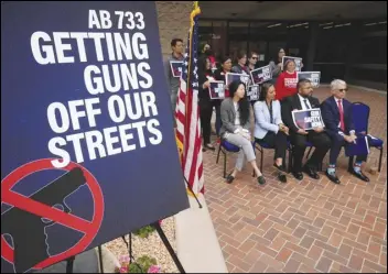  ?? ASSOCIATED PRESS in Monterey Park ?? Lawmakers, prosecutor­s and survivors attend a news conference Monday announcing three new laws aimed at getting guns off California streets.