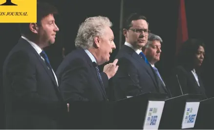  ?? ADRIAN WYLD/THE CANADIAN PRESS ?? Conservati­ve leadership candidates Jean Charest and Pierre Poilievre spar as Roman Baber, Scott Aitchison and Leslyn Lewis look on during a debate in Ottawa on Thursday.