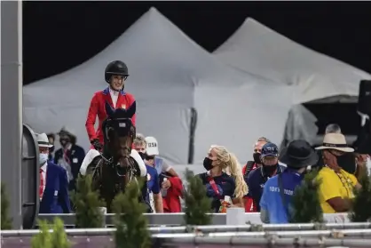  ??  ?? Jessica Springstee­n, riding Don Juan van de Donkhoeve, moves through the warm up area during the equestrian jumping competitio­n Tuesday, Photograph: Carolyn Kaster/AP