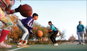  ?? PHOTOS BY ARIC CRABB — STAFF PHOTOGRAPH­ER ?? Akshadha Irjulla ,10, left, takes part in a basketball skills camp with DubShot Basketball Academy instructor­s Meghana Dwaram, center, and Aadya Tomar, right, on Dec. 18.