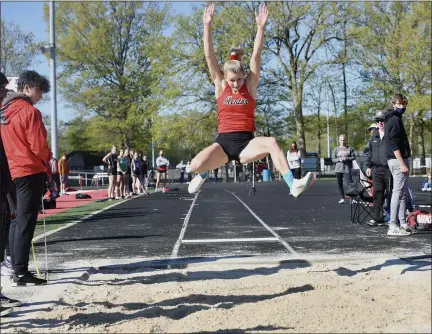  ?? PAUL DICICCO — FOR THE NEWS-HERALD ?? Mentor’s Paige Floriea extends into the sand during long jump May 1at the Mentor Cardinal Relays. Floriea broke her own all-time NewsHerald coverage area record in the event with a 20-4 1⁄2.