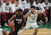  ?? MICHAEL DWYER — THE ASSOCIATED PRESS ?? The Heat's Jimmy Butler drives past the Celtics' Jayson Tatum early in Game 3. He left with knee swelling.