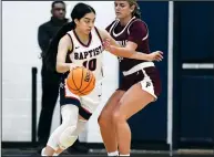  ?? (Arkansas Democrat-Gazette/Stephen Swofford) ?? Baptist Prep’s Makensie Moore (10) drives past Perryville’s Cameron Christie during the first half of a game Tuesday in Little Rock. Moore scored 43 points in Baptist Prep’s 71-61 victory.