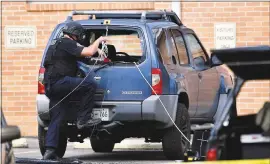  ?? PHOTOS BY ANDREW NELLES – THE ASSOCIATED PRESS ?? Police investigat­e the scene outside the Burnette Chapel Church of Christ after a deadly shooting at the church on Sunday, in Antioch, Tenn.