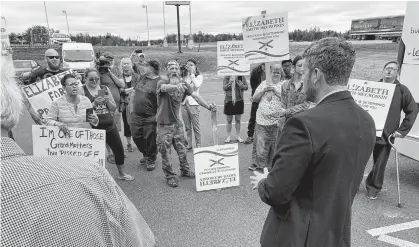  ?? DARRELL COLE • SALTWIRE NETWORK ?? Liberal Leader Iain Rankin is heckled during a visit to Amherst Tuesday during which he announced that under a Liberal government, non-commercial Nova Scotia drivers would no longer have to pay the toll to use the Cobequid Pass after Oct. 1.