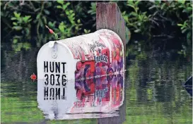  ?? [AP PHOTOS] ?? A flooded mailbox is reflected in the water in Lumberton, N.C., Monday in the aftermath of Hurricane Florence.