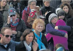  ??  ?? HEARTBREAK: A solemn crowd, left, listens to a speaker during a vigil on Boston Common yesterday for the Tree of Life synagogue shooting victims.