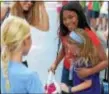  ?? PETE BANNAN — DIGITAL FIRST MEDIA ?? Amina, 11, center, gets a welcome back hug from Emily Negrey, 7, and her sister Mia, 9, and mom, ELise Piebenga-Negray, left, of Wayne at the Fresh Air Fund welcome at Shipley School in Bryn Mawr Monday.