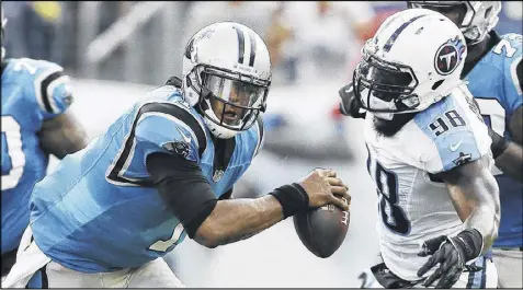  ?? JAMES KENNEY / AP ?? Panthers quarterbac­k Cam Newton eludes the grasp of Titans linebacker Brian Orakpo (98) during a first-half play in Saturday’s preseason game at Nashville. Severe weather caused a 30-minute delay in the second half.