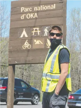  ?? PHOTOS: RYAN REMIORZ/ THE CANADIAN PRESS ?? Mohawks from Kanesatake block the entrance to Oka provincial park in Quebec last
week. They worry the partial reopening of the park will increase COVID-19 risks.