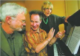  ?? ASSOCIATED PRESS FILE PHOTO ?? Composer John Adams, from left, listens to director Peter Sellars as he explains his idea in 2005 about the premiere of Adams’ opera, Doctor Atomic, as San Francisco Opera’s general director Pamela Rosenberg looks on.