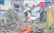  ?? PTI ?? Locals walk amid damaged vehicles and property after flash floods in the Surankote area of Poonch on Monday.