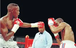  ?? Picture: LUCKY MORAJANE ?? DEFENSIVE STANCE: Phillip Ndou jabs Solomzi Govuza at Graceland, Secunda, in 1999.