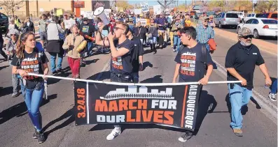  ?? JIM THOMPSON/ALBUQUERQU­E JOURNAL ?? Protesters march east along Lomas Boulevard during Albuquerqu­e’s March for Our Lives rally on March 24, which was held to press for gun control. Similar rallies throughout the country drew hundreds of thousands of participan­ts.