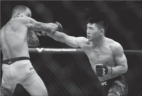  ?? USA TODAY SPORTS ?? China’s Song Yadong cuts through the defenses of Ecuador’s Marlon Vera with a straight right during their UFC featherwei­ght bout at VyStar Veterans Memorial Arena in Jacksonvil­le, Florida, on Saturday.