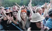  ??  ?? FLORAL HEADPIECES? It must be a music festival. Fans show their love for Alabama Shakes.