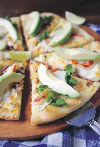  ??  ?? Pizza is topped with seafood, wasabi lime cream, avocado, pancetta and cheese.