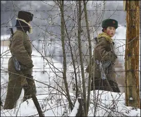  ?? AP ?? North Korean soldiers patrol near the China-North Korea border in Dandong on Sunday.