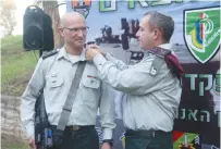  ?? (IDF) ?? COL. SHARON ASMAN (left) receives new ranks from OC Southern Command Maj.-Gen. Eliezer Toledano earlier this week.