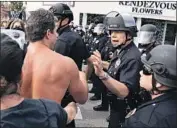  ?? Kent Nishimura Los Angeles Times ?? POLICE CHIEF Michel Moore talks to protesters at a George Floyd protest in the Fairfax district in May.