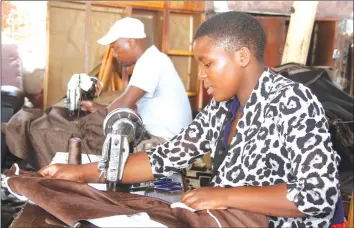  ??  ?? ENTERPRISI­NG . . . Fadzi Kombera (right) and Mr Nhamo Mureriwa sew sofa covers at Glen View Home industry in Harare last week. — (Picture by Kudakwashe Hunda)